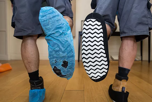 Side-by-side comparison of The Original CleanBoot<sup>®</sup> next to a torn, used disposable plastic overshoe – highlighting the difference in quality, durability, and professionalism.