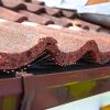 Alternate angle of Birdcomb installation under tiles, demonstrating alignment with roof profile
