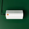 Top-down view of the Goodnature trap while charging via USB cable on a green background