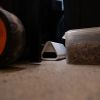 Goodnature Mouse Trap placed discreetly in a garage beside a container of screws and a trolley wheel.